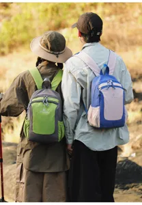 Outdoor travel backpack detail showing color-blocking design, durable straps and front pocket.