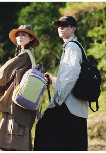 Outdoor lifestyle scene showing models wearing color-blocking and black casual backpacks.