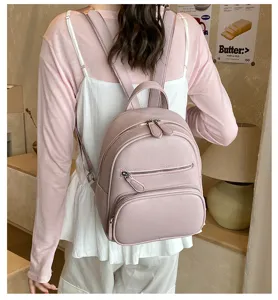 Stylish pink leather mini backpack for women, casual daily wear small daypack detail view.