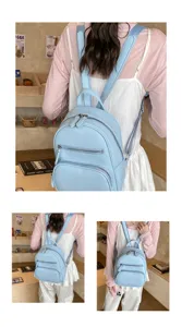 Stylish casual light blue leather backpack for women, multi zipper pockets, detailed back view.