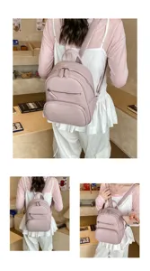 Detailed view of a stylish pink leather backpack featuring multiple zip pockets and straps.