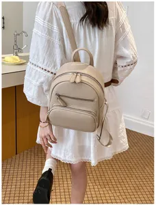 Detail view of a stylish beige PU leather mini backpack for women, casual multi-use shoulder bag.