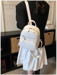 Detailed shot of casual white leather backpack for women, featuring zip pockets and straps.