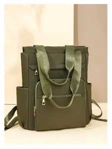 Close-up detail of the durable green oxford cloth convertible backpack and tote bag structure.