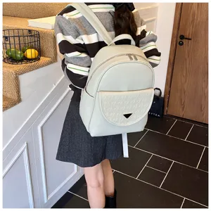 Solid color women's PU leather backpack, casual fashion travel bag with front pocket detail.