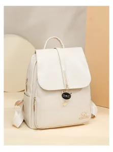 Stylish women's leather backpack with flap closure and cute cat pendant for daily use and travel.