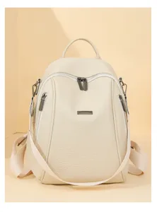 Detail shot of beige faux leather women backpack, stylish front zippers for daily commute.