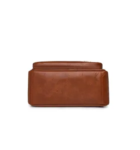 Bottom detail shot of retro brown leather backpack, showing durable texture and neat stitching.