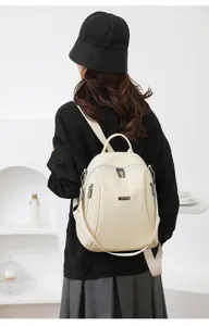 Beige faux leather women's backpack detail view, casual commuter bag with secure zip pockets.