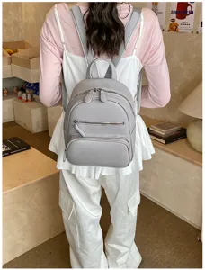 Stylish gray leather backpack for women, casual daily travel daypack with multiple zipper pockets.