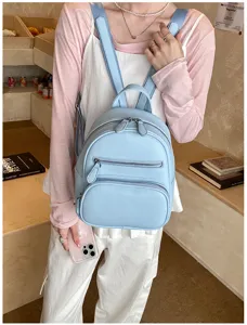 Casual women's mini leather backpack in light blue, multi-pocket stylish daypack.