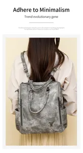 Back view detail of vintage wash multi-functional leather backpack with adjustable straps.