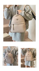 Detail view of a beige PU leather backpack with a metal triangle logo worn on stairs.