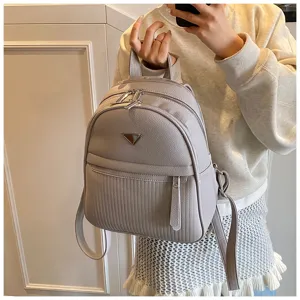 Detailed view of grey PU leather women backpack, minimalist casual travel daypack design.