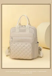 Quilted leather backpack detail, solid color rivet design with smooth zipper and handle.