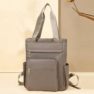 Stylish multifunctional nylon backpack for women, convertible tote and shoulder bag.