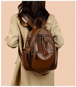 Brown leather multi-pocket casual backpack detail showing stylish travel bag design.