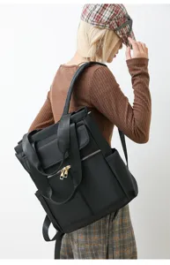 Vue detaillee du sac a dos noir elegant pour femmes avec fermetures eclair dores sur le modele.
