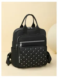 Stylish black quilted rivet women backpack, detailed view of the fashion casual daypack.