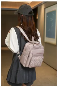 Detail view of a stylish women backpack featuring quilted design, metal studs, and multi pockets.