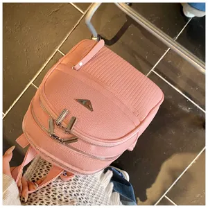 Detail view of stylish pink PU leather women backpack with dual zippers and front pocket.