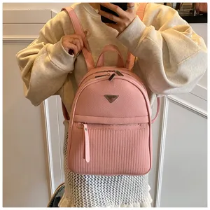 Detail view of pink leather backpack, casual daily commuting travel women school bag.