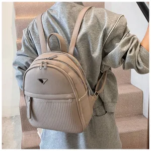 Casual PU leather backpack for women, stylish travel daypack with multiple zipper compartments.