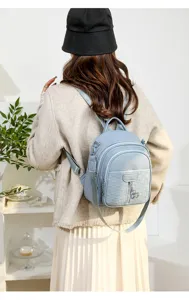 Light blue PU leather casual women backpack detail view, stylish daily commuter school bag.