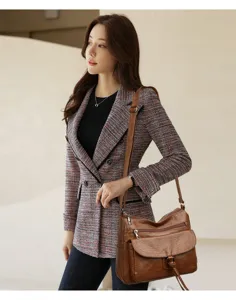 Close-up detail of the soft leather shoulder bag with multi pockets and adjustable strap.