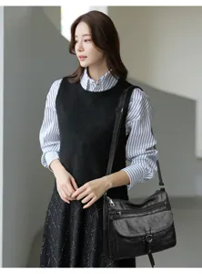 Soft leather shoulder crossbody bag for middle-aged women with multi zip pockets.