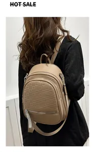 Detailed view of women's fashion debossed backpack, stylish shoulder bag with rhinestone zipper.