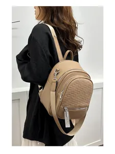 Detail shot of khaki PU leather backpack with geometric embossed pattern and crystal zipper pull.
