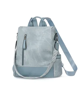 Close-up detail of the light blue women soft leather backpack with stylish front zipper pocket.
