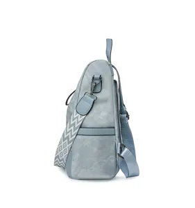 Side view of a light blue soft leather women backpack with a wide geometric strap.