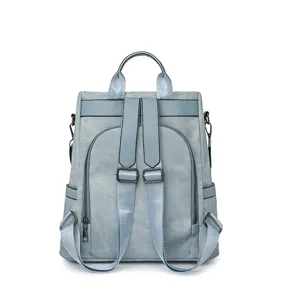 Backpack detail showing soft leather texture, sturdy shoulder straps and hardware.