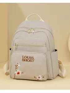 Stylish casual women backpack with delicate floral embroidery and front pocket design.