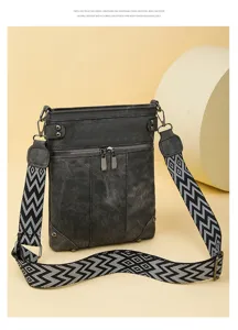 Detailed view of the retro canvas shoulder bag with geometric patterned strap and pockets.