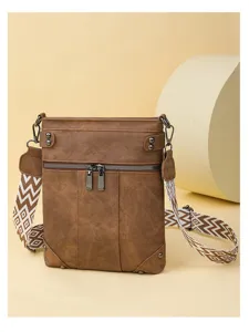Brown vintage crossbody bag with geometric strap, multi-pocket design and chic metal zippers.