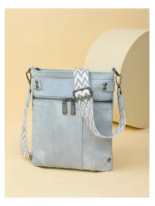 Stylish light blue denim shoulder bag with patterned wide strap, multi-pockets and vintage design.