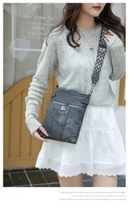 Detail view of the vintage PU leather crossbody bag with multi pockets and wide patterned strap.