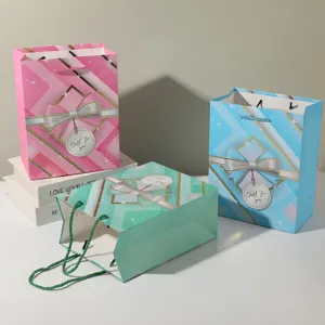 Decorative paper gift bags with bows and handles, ideal for party favors and shopping packaging.
