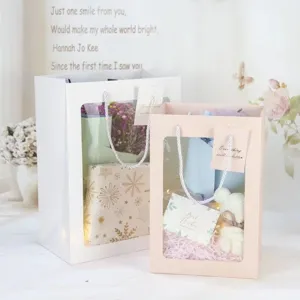 Open window paper gift bag with handles, pink and white packaging bag for flowers and gifts.