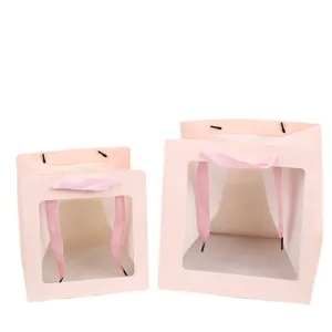 Bolsa de regalo de papel rosa con ventana transparente y asa de cinta para bodas y fiestas.