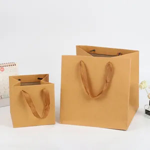 Square kraft paper gift bags with fabric handles for birthday cakes and flower bouquets.