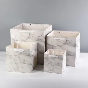 Detailed view of square marble pattern paper gift bags in multiple sizes for elegant packaging.