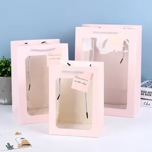 Pink transparent window paper gift bag, ideal for flowers, party favors and holiday packaging.