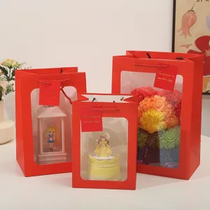 Red gift bags with transparent windows, ideal for Valentine's day, flowers and couple gifts.