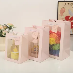 Pink paper gift bag with clear window, perfect for romantic flower packaging, gifts and parties.