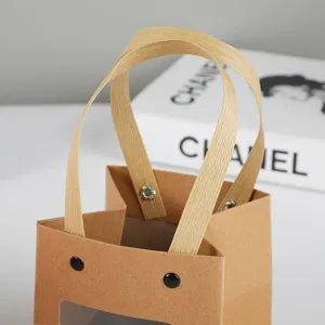 Kraft paper window gift bag with paper handles and rivets, ideal for packaging flowers or gifts.