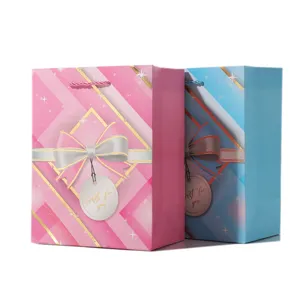 Gift bags set with bow and geometric print, paper shopping bags for party and presents.
